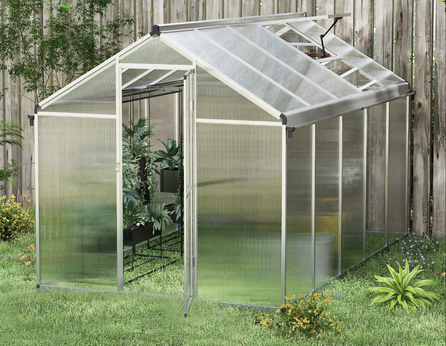 Greenhouse with transparent walls and a metal frame in a garden setting.