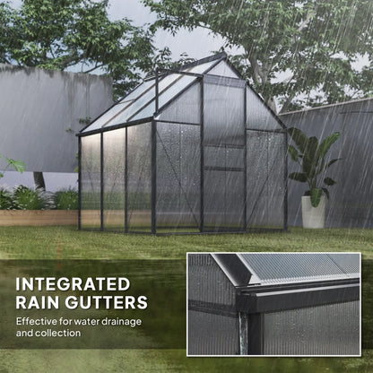 Greenhouse with integrated rain gutters during rain, showing water drainage system.