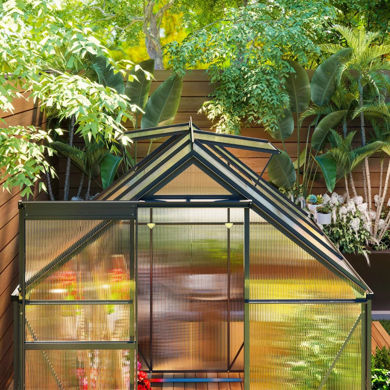 Greenhouse with plants and garden decor in a backyard setting