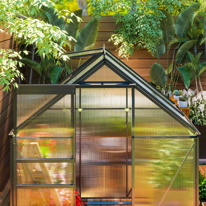 Small greenhouse with plants and garden furniture in a backyard setting