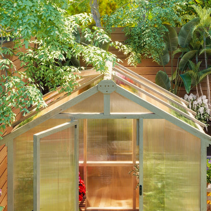 Greenhouse with transparent walls and a wooden roof, surrounded by greenery.