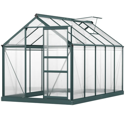 Green metal greenhouse with transparent panels on a white background