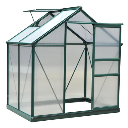 Green metal greenhouse with transparent glass panels on a white background