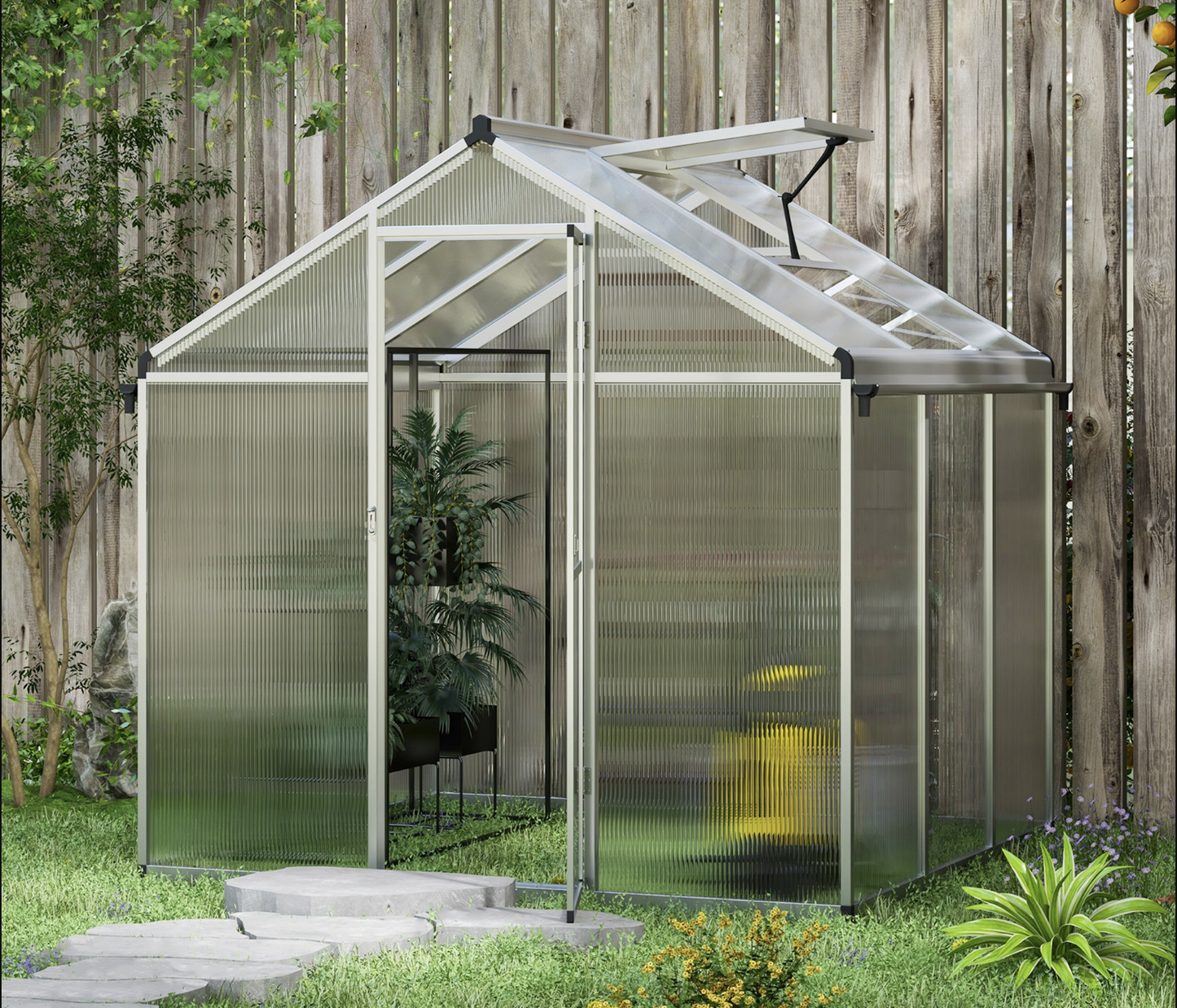 Greenhouse with transparent walls and a wooden fence in the background