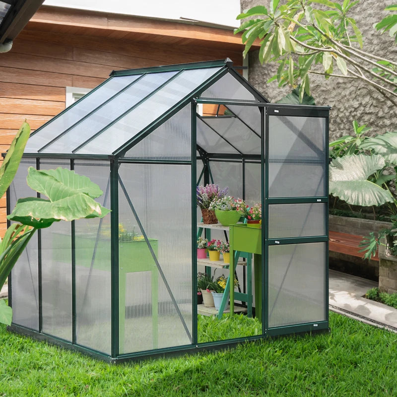 Greenhouse with plants inside, set against a garden backdrop