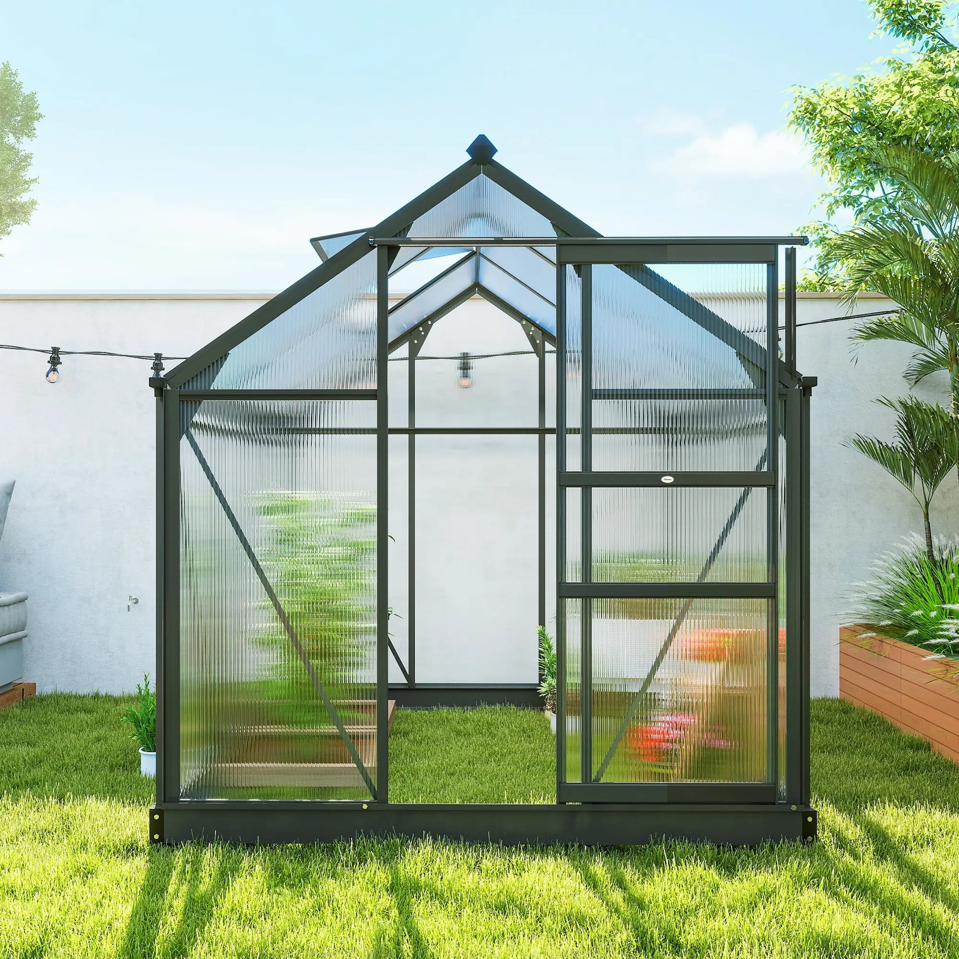 Greenhouse in a garden with grass and plants