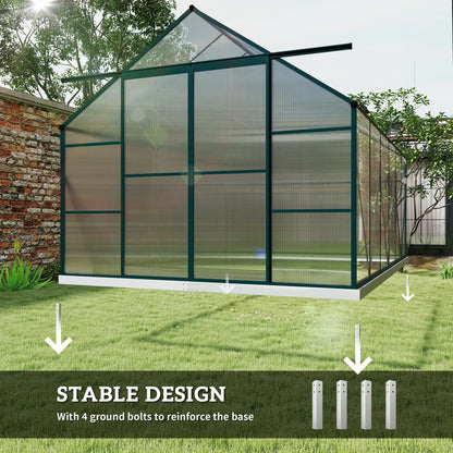 Greenhouse with stable design feature highlighted on a grassy area with a brick wall in the background.